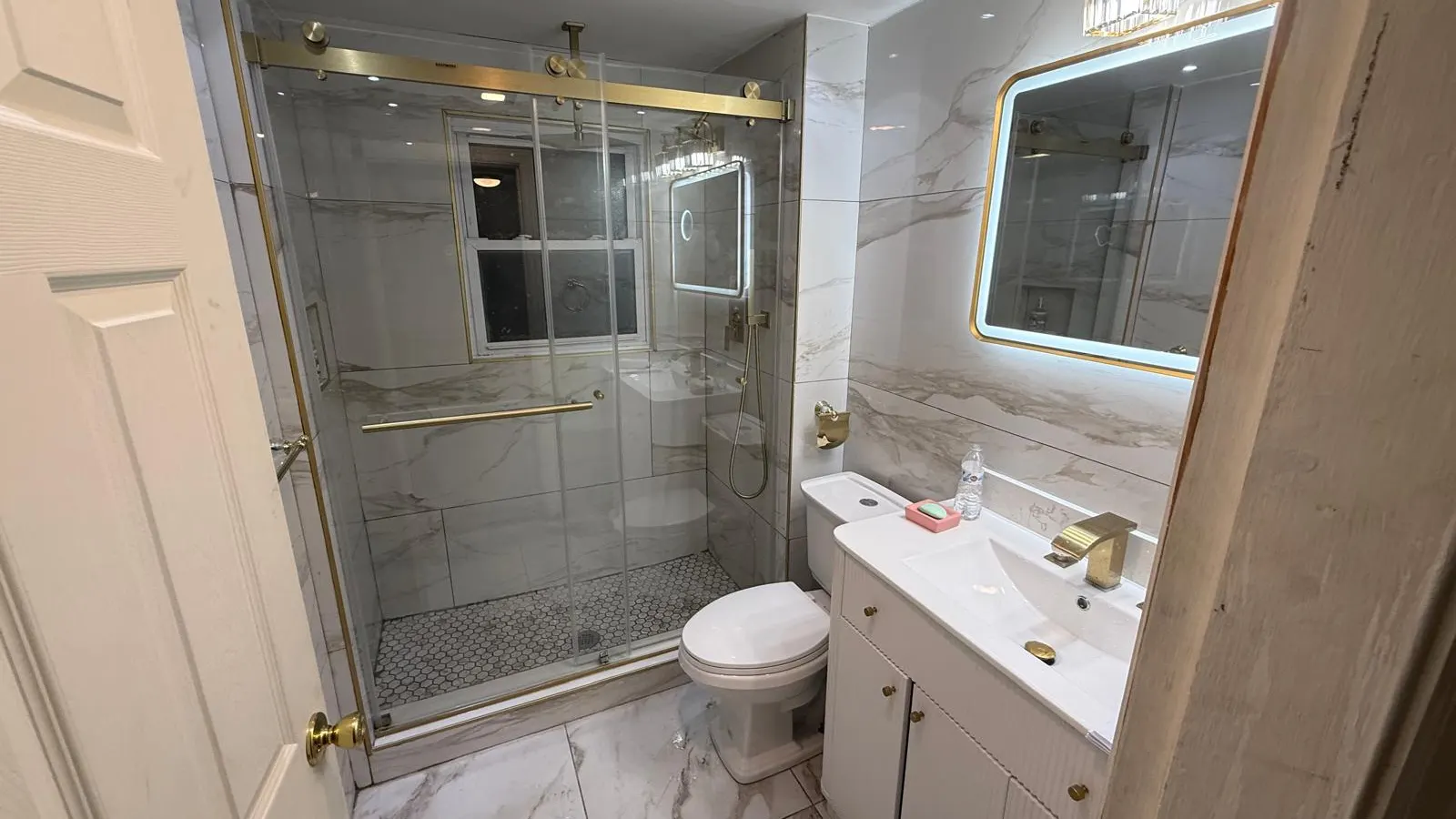 Bathroom remodeling in Lynn, MA with tile shower and glass door