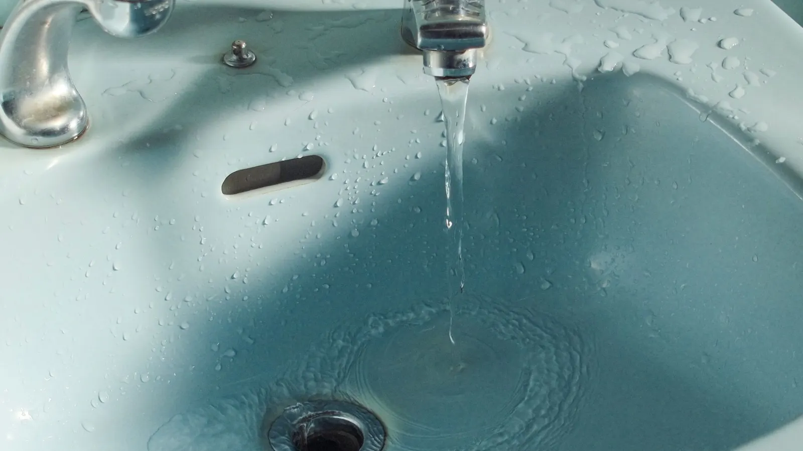 Drain cleaning in Lynn, MA, water running down a sink drain