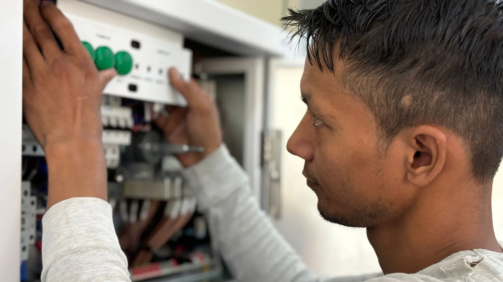 Electrical panel upgrade in Lynn, MA showing a technician working on a breaker panel