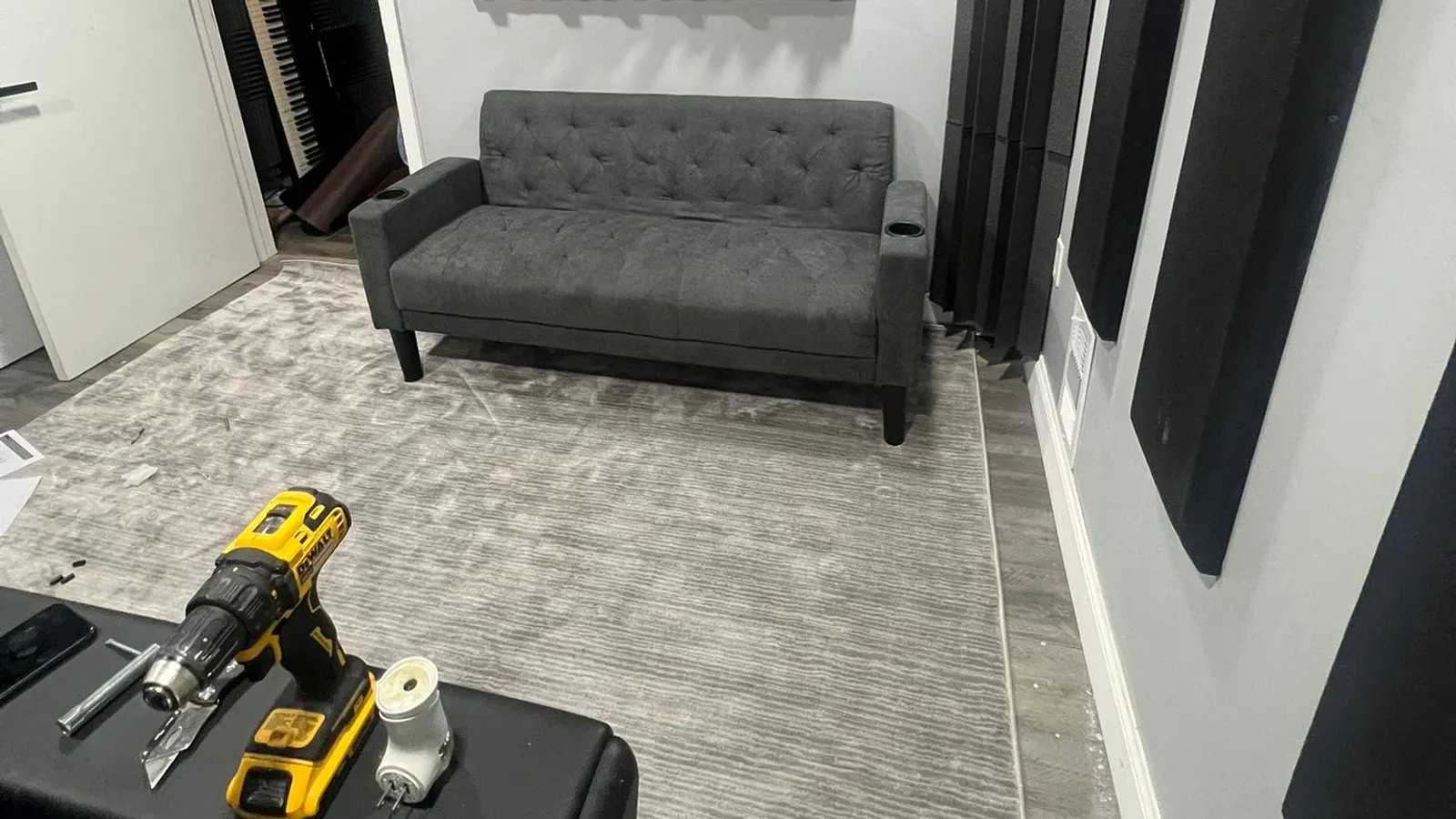 Contractor services in Lynn, MA, a finished basement room with a sofa and tools